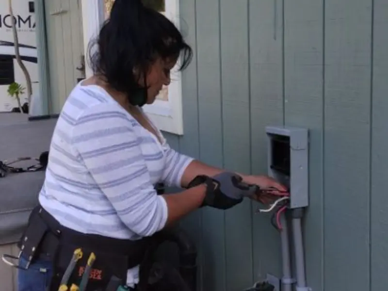 Licensed electrician wiring an exterior subpanel in Strafford